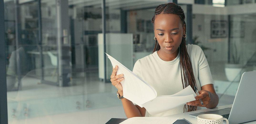 A woman reviews her credit card statements.